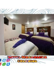 a room with three beds with purple and white sheets at Hotel Magdalena Colonial in Guanajuato