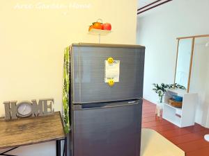 a refrigerator with an apple on top of it at Aree Garden Home Private Homestay by the Waterfall Chantaburi - บ้านสวนพลิ้วอารี ริมธารน้ำตกพลิ้ว จันทบุรี 