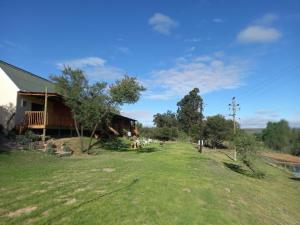a house on a hill with a large yard at Cango's Rest in Oudtshoorn