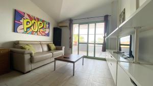 a living room with a couch and a table at Apartamento Moradias in Santa Maria