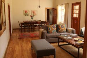 a living room with a couch and a table at House at Glengariff in Underberg