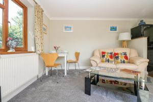 a living room with a couch and a table at Silverwell Forge in Chacewater