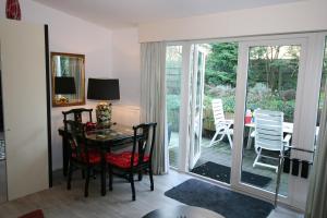 a dining room with a glass table and chairs at Villa 't Haasduin in Wijk aan Zee