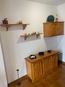 a room with wooden cabinets and shelves on the wall at Can Tersi in Setcases