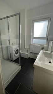 a bathroom with a shower and a sink and a toilet at My Apartment im Bremer Viertel in Bremen