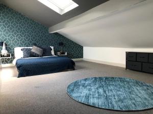 a bedroom with a bed and a blue rug at Ocean View Apartments - Belgravia in Blackpool