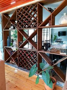 a wooden wine cellar with a bunch of wine bottles at Hotel Mountain Mestia in Mestia