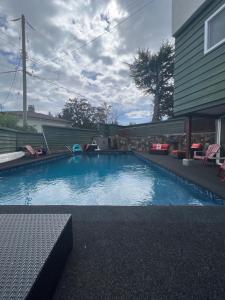 a swimming pool in the backyard of a house at Tranquil Oasis 2 bedroom Suite with Pool View in Victoria