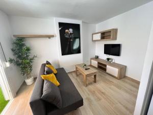 een woonkamer met een bank en een tv bij ÁTICO VISTA TEIDE in Arona