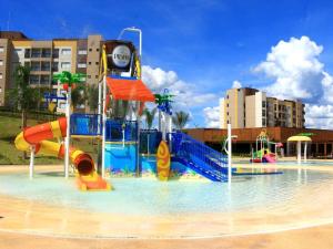 a water park with a water slide in the water at Resort Praias do Lago in Caldas Novas
