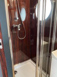 a shower with a glass door on a boat at Couston Lakes Resorts in Bathgate +58 photos
