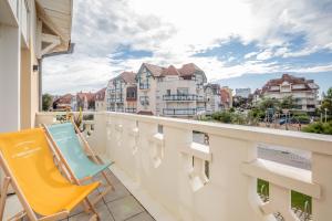 einen Balkon mit einem Stuhl und Stadtblick in der Unterkunft La Clé de Quentovic ◎ Duplex de 150 m2 ◎ Standing in Le Touquet-Paris-Plage