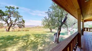 a porch of a house with a view of a field at Pack Creek ~ Orchard House in Moab