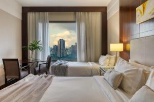 Cama ou camas em um quarto em Mercure Belo Horizonte Lourdes