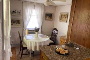 a kitchen with a table and a table and a window at Plum Crooked Poets Cottage - Walk to Town - Luxury King Bed - Near Asheville - Excellent Wi-Fi in Marshall
