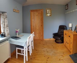 a dining room with a table and chairs and a door at Jakels Rest in Lairg