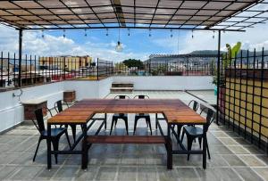 a wooden table and chairs on a patio at Hostal Nordés in Oaxaca City
