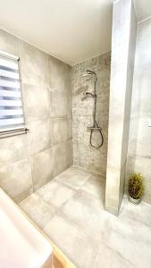 a bathroom with a shower and a tub at Apartament 21 (1) in Szczyrk