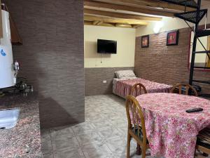 two photos of a room with a table and a bedroom at Departamento nazuc in San Rafael