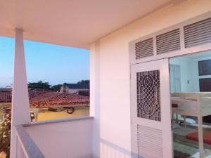 a door to a balcony with a view at Guará Hostel in São Luís