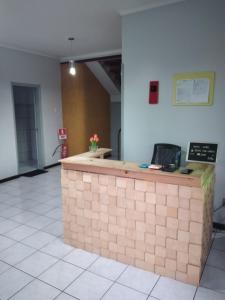 an empty lobby with a counter in a room at Guará Hostel in São Luís