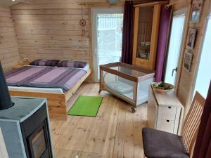 a bedroom with a bed and a table in it at Chalet im Spiel- und Obstgarten in Keidelheim