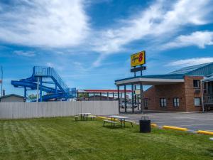 a mcdonalds building with a playground and a slide at Super 8 by Wyndham Hardin Little Bighorn Battlefield in Hardin