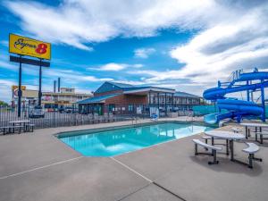 a swimming pool with a slide and a water park at Super 8 by Wyndham Hardin Little Bighorn Battlefield in Hardin