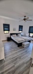 a bedroom with a large bed and a wooden floor at La Casa de Lucy & Karin in La Orotava