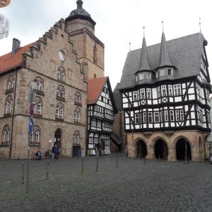 an old building with a clock tower next to at Alsfelder Apartment I in Alsfeld