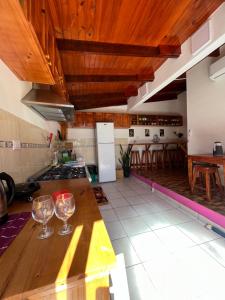 a kitchen with two wine glasses on a counter at Alojamientos Iguazú in Puerto Iguazú