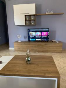 a living room with a tv and a coffee table at Guest House Tian in Durrës