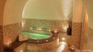 a large bathroom with a tub with lights in it at Dimora Storica Torre Del Parco 1419 in Lecce