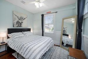 a bedroom with a bed and a mirror at Beautiful Historic Downtown Charleston Home in Charleston