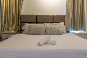 Ένα ή περισσότερα κρεβάτια σε δωμάτιο στο Desaru BabyFriendly Homestay