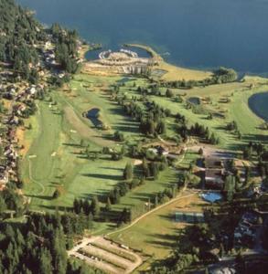 an aerial view of a golf course with trees and water at Deer Haven Apartment in Bellingham