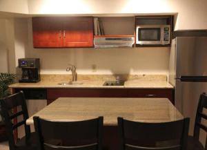 a kitchen with a table with chairs and a microwave at Deer Haven Apartment in Bellingham