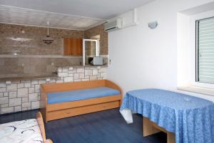 a small room with a table and a kitchen at Apartments with a swimming pool Soline, Dubrovnik - 4762 in Mlini