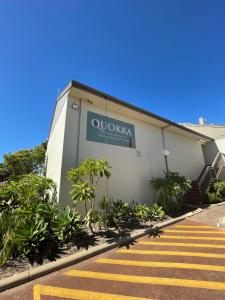 a building with a sign on the side of it at Tranquility at Mandurah Apartments in Mandurah