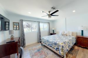 a bedroom with a bed and a ceiling fan at Portola Oasis in Monterey