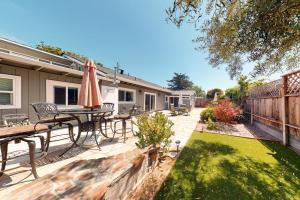 a patio with a table and chairs and an umbrella at Portola Oasis in Monterey