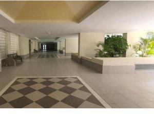a lobby with a checkered floor in a building at Apartamento Costa de la Luz in Rota +25 photos