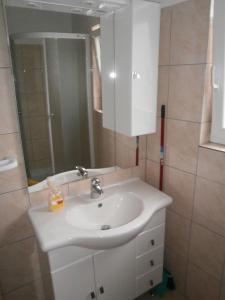 a bathroom with a white sink and a mirror at Apartment Maja in Vodice