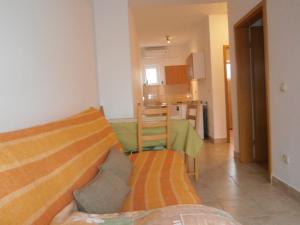 a living room with a couch and a kitchen at Apartment Maja in Vodice