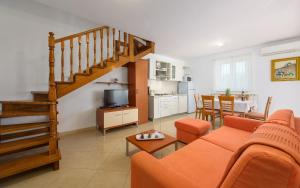 a living room with a couch and a staircase at Family friendly apartments with a swimming pool Basanija, Umag - 3402 in Savudrija