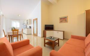 a living room with a couch and a table at Family friendly apartments with a swimming pool Basanija, Umag - 3402 in Savudrija