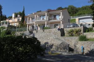 a house on top of a stone wall at Apartment Medveja 3430b in Medveja