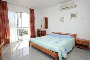 a bedroom with a bed and a large window at Apartments by the sea Medveja, Opatija - 3430 in Medveja
