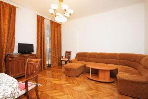 a living room with a couch and a table at Apartments with a parking space Opatija - 3436 in Opatija