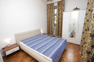 a bedroom with a large bed and a mirror at Apartments with a parking space Opatija - 3436 in Opatija